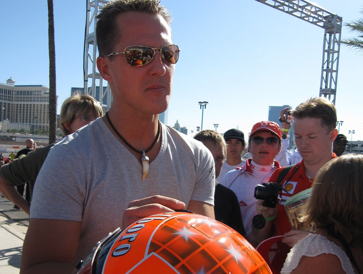 Michael Schumacher signing a helmet